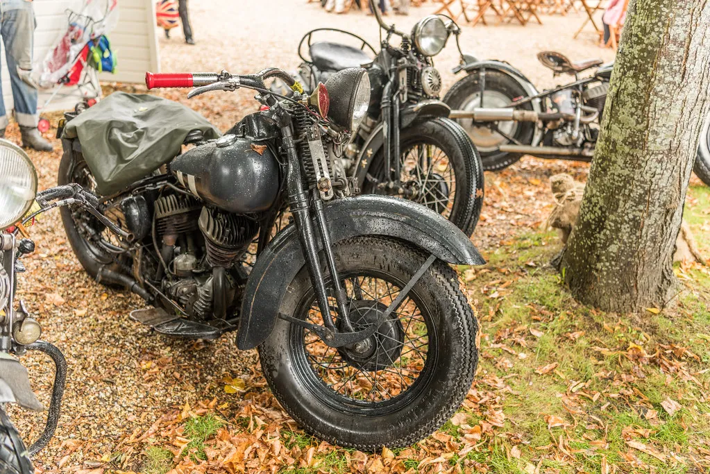 Bobber motorcycle in raking sunlight on concrete